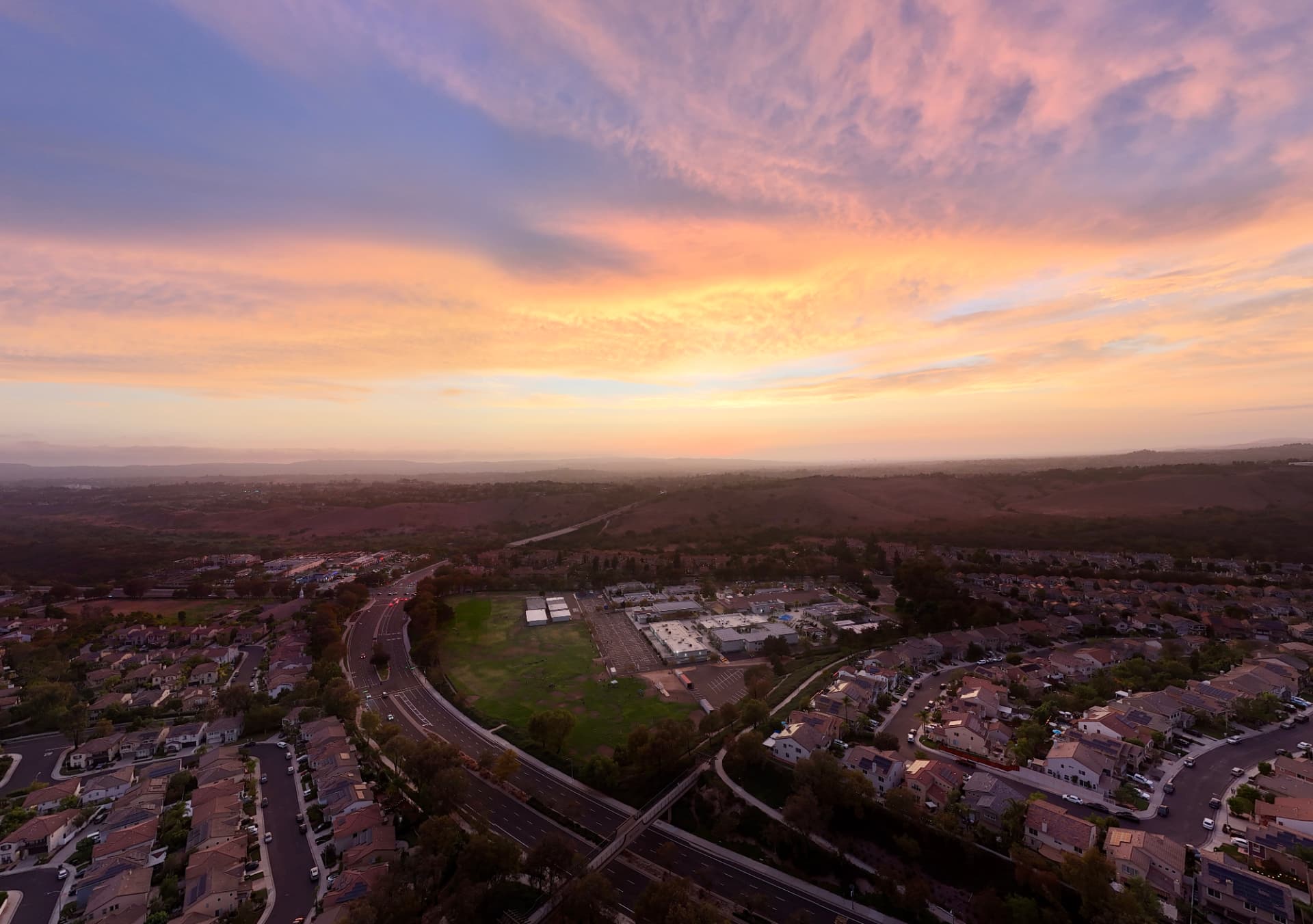 Evening light over Las Flores, California, with homes, parks and the surrounding hills