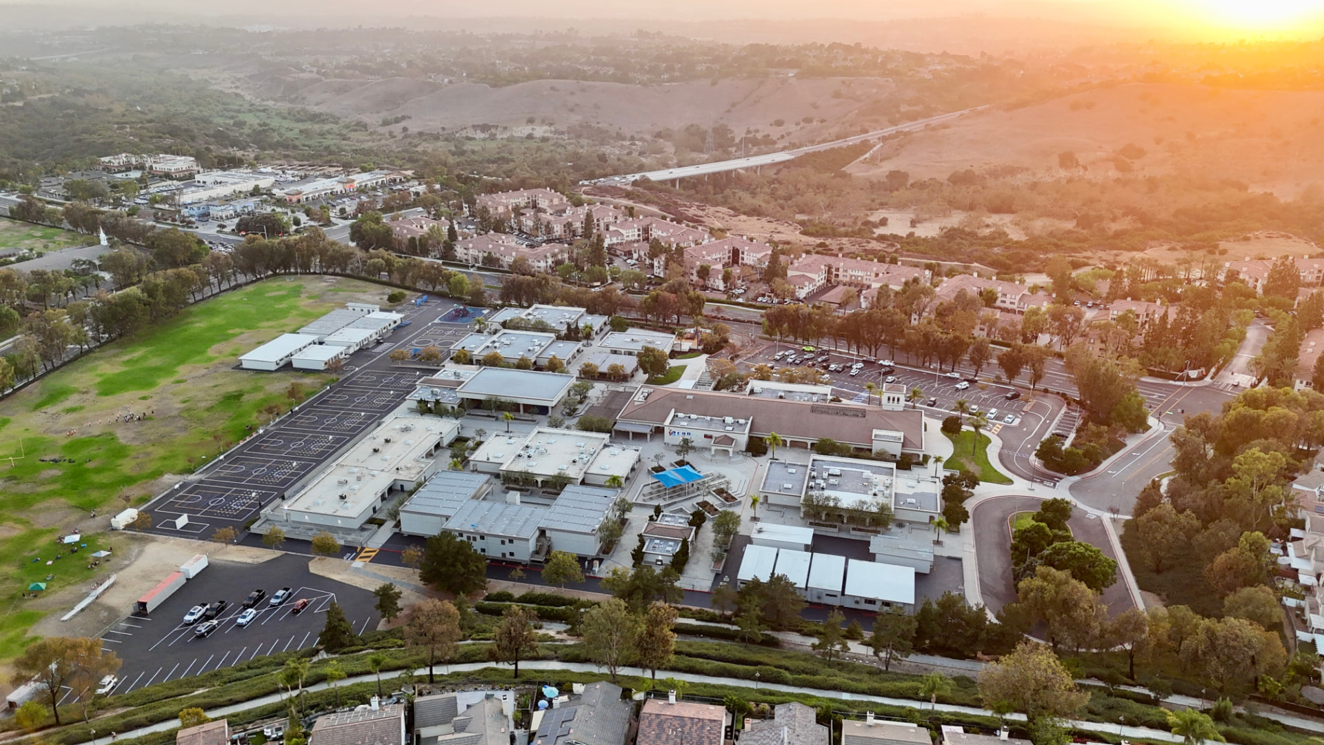 Aerial view of Las Flores TK-8 school campus and fields at sunset